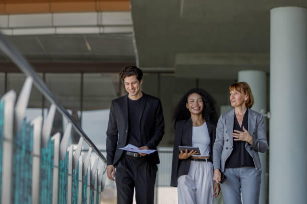 Corporate VC professionals walking together in modern office corridor